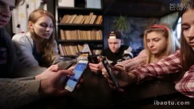 一群坐在木桌前围成一圈，在咖啡馆用智能手机<strong>上网</strong>的<strong>青少年</strong>聚精会神